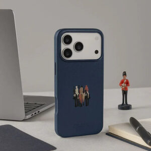 Blue leather iPhone 17 Pro Max case with a small figure figurine nearby.