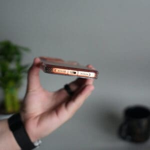 Elegant iPhone 17 Pro case with hanging rope bracket and AI button design.